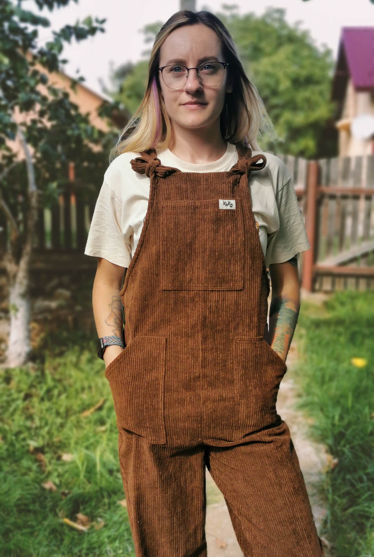 female model posing in YAYS unisex dungarees in Bark Brown, front view