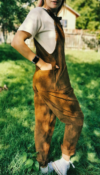 female model posing in YAYS unisex overalls in Bark Brown, back view