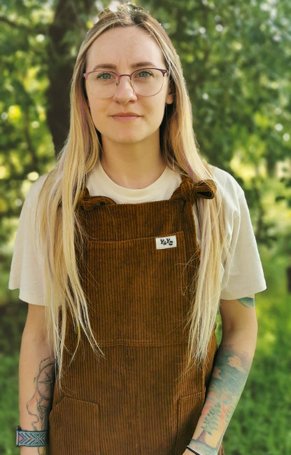 Female model posing in YAYS unisex overalls in Bark Brown, front view, close-up