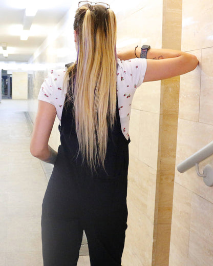 woman wearing YAYS unisex cotton dungaree in Raven Black, back view