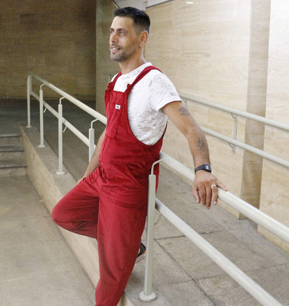 Male model posing in YAYS dingaree in scarlet red, side view 