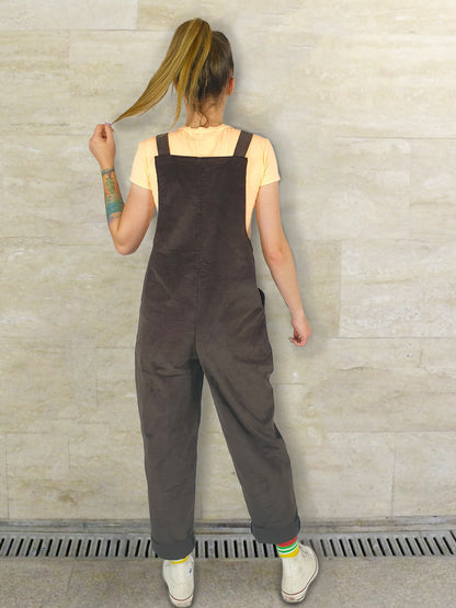 female model, wearing YAYS unisex dungarees in Umber Brown, back view