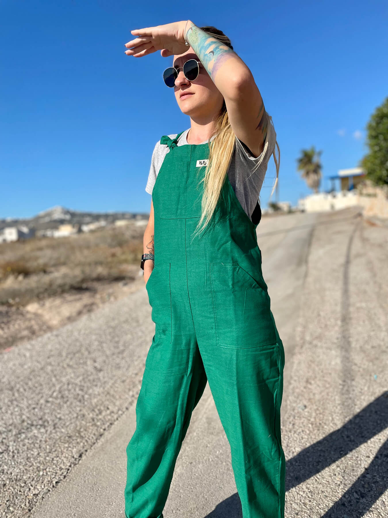 woman wearing YAYS linen unisex dungarees in Spring Green, posing front view