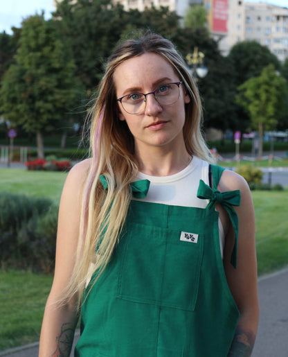 woman wearing YAYS linen unisex overalls in Spring Green, posing, close-up